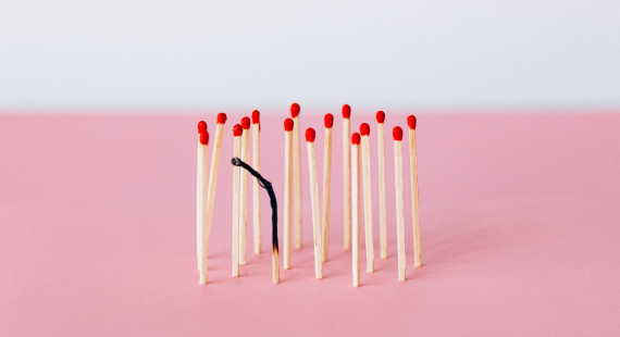 Burnout and stress: A bundle of unlit and burned out matches are seen against a pink background